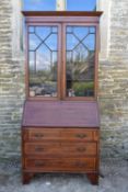 An Edwardian mahogany and satinwood inlaid bureau bookcase with upper astragal glazed section