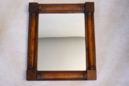A Regency mahogany wall mirror with turned pilasters to each side. H.53 W.45cm