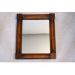 A Regency mahogany wall mirror with turned pilasters to each side. H.53 W.45cm