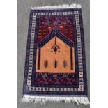 A hand made Zekhani Belouch prayer rug with sand and burgundy ground within geometric borders. L.170