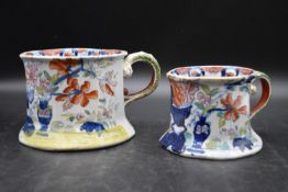 A pair of early 20th century handpainted ironstone jugs with floral decoration. Stamped to base. H.