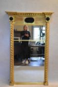 A large 19th century gilt framed pier mirror with architectural cornice above shell decorated frieze