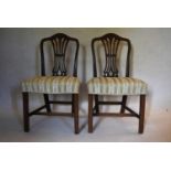A pair of Georgian mahogany Hepplewhite style dining chairs with pierced vase shaped splats above