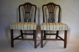 A pair of Georgian mahogany Hepplewhite style dining chairs with pierced vase shaped splats above