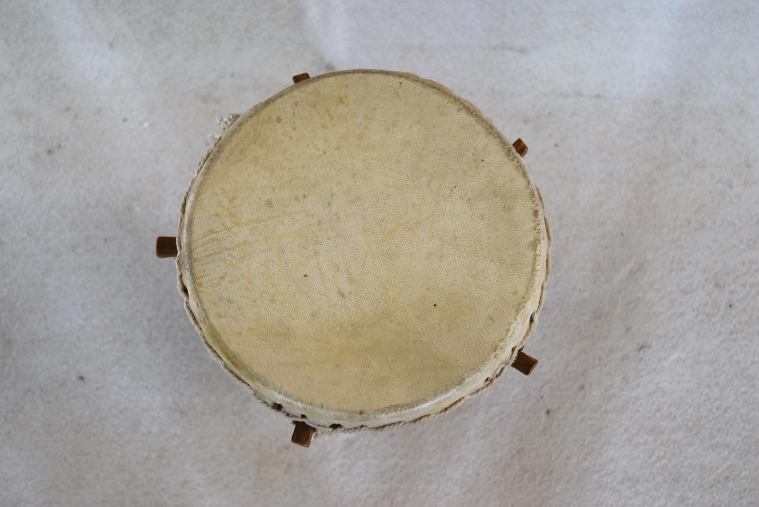 A Senegalese painted hardwood tribal drum. H.44 W.25cm - Image 4 of 6