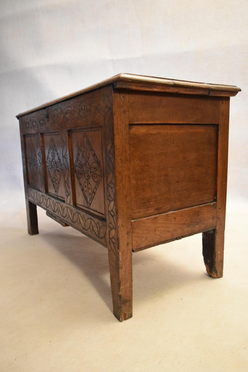 An 18th century country oak coffer with its original hinges and lozenge carved panels raised on - Image 4 of 10