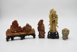 A collection of 20th century Chinese carved soapstone figures. Including a boulder mountain