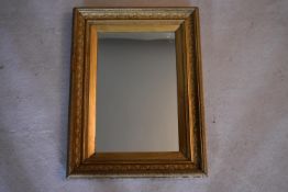 A 19th century wall mirror in giltwood and gesso frame. H.63 W.48cm
