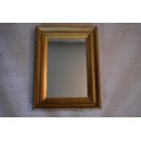 A 19th century wall mirror in giltwood and gesso frame. H.63 W.48cm