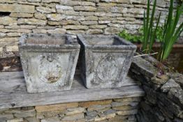 A pair of weathered reconstituted stone garden planters with Prince of Wales Feather relief