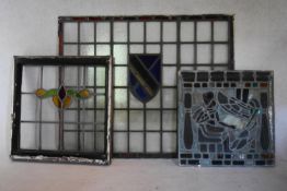 A vintage stained and leaded glass window pane with central heraldic detail along with two other