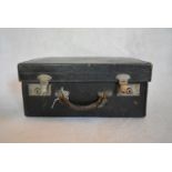 A vintage leather travelling case with gilt embossed monogram. H.24 W.44 D.33cm