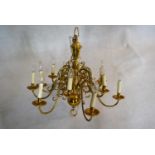 A large Dutch style brass chandelier with twelve scrolling branches in two tiers. H.81 W.85cm
