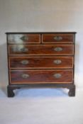 A Georgian mahogany crossbanded and satinwood inlaid chest of drawers on ogee bracket feet. H.100