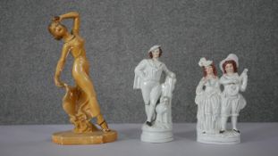 Two 19th century Staffordshire pottery flat back figures, one of a male and female and a young boy