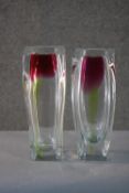 Two art glass vases with a stylised purple tulip design. (one chipped) H.30cm.