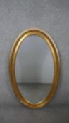 A large 20th century gilt framed wall mirror with beaded detailing. H.126 W.75cm