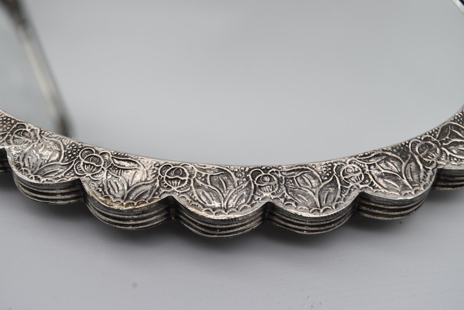 A 20th century Indian silver repousse mirror with stylised foliate and floral design and hanging - Image 2 of 8