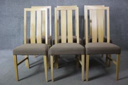 A set of six contemporary slat back light oak dining chairs with upholstered seats on square