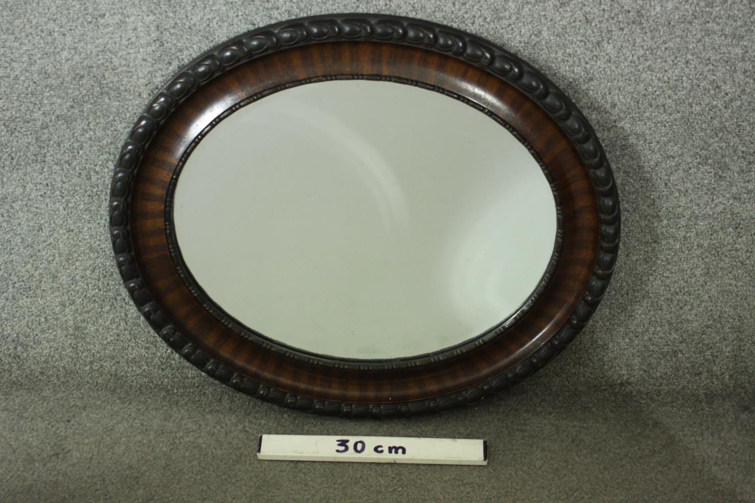 An early 20th century painted and lacquered framed oval wall mirror with bevelled plate. H.57 W. - Image 3 of 3