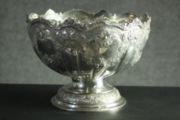 A large Victorian repousse silver pedestal punch bowl. Decorated all over with roses, floral