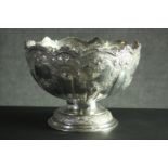 A large Victorian repousse silver pedestal punch bowl. Decorated all over with roses, floral