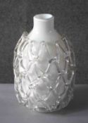 A white and clear Art Glass vase with open work netting design. Label verso. H.31 Diam.20cm.