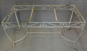 A wrought iron and painted garden table base. H.76 W.153 D.77cm