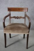 A Regency mahogany bar back armchair on reeded sabre supports.