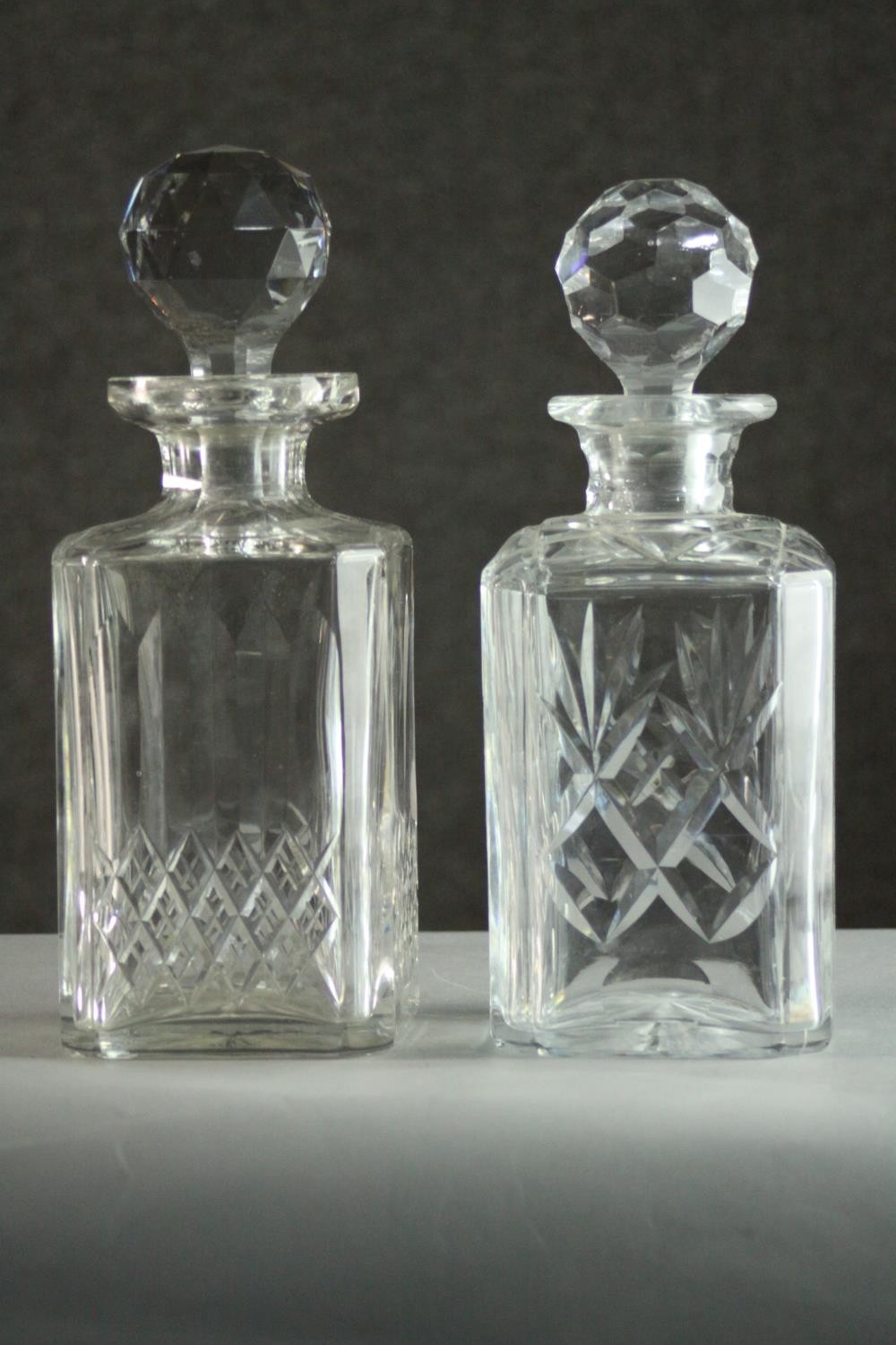 Two cut crystal decanters with stoppers. H.25cm.