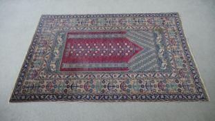 A Turkish Kayseri prayer mat with burgundy ground and floral multiple borders. L.170 W.115cm
