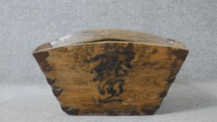 An early 20th century Chinese handled rice measurer with hand painted characters. H.19 W.39 D.39cm