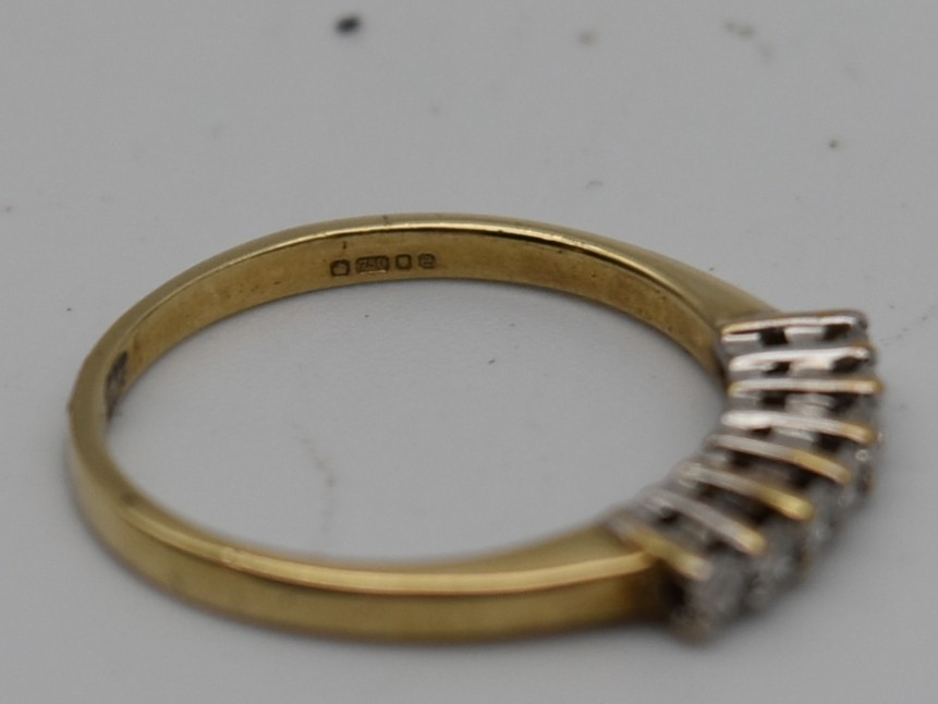 A seven stone diamond and 18 carat gold ring. Set with seven round brilliant cut diamonds in open - Image 4 of 7