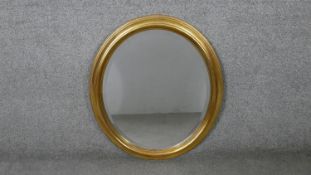 An oval gilt framed mirror. H.71 W.61cm