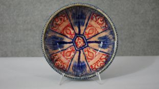 A Persian glazed ceramic bowl, the interior decorated with floral motifs, marked and dated to