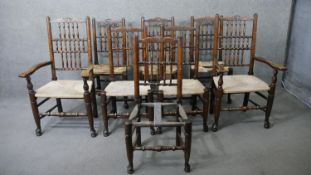 A set of eight Lancashire style oak spindle back dining chairs with woven seats on stretchered pad