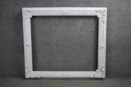 A large early 20th century carved and painted picture frame with foliate design. H.92 W.100 cm. W.80