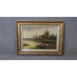 J. Cole (19th Century) A 19th century gilt framed oil on canvas of a riverscape with cottages.