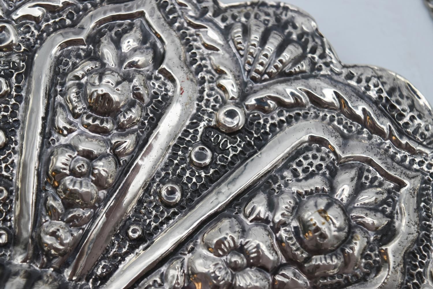 A 20th century Indian silver repousse mirror with stylised foliate and floral design and hanging - Image 5 of 8