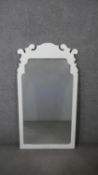 A white painted carved pier mirror with fretwork cresting. H.132 W.71cm