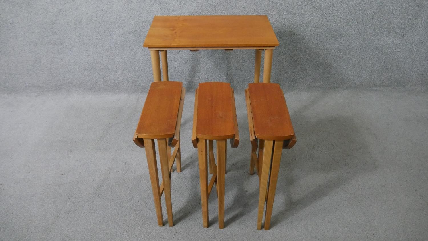 A vintage light teak nest of tables on beech supports fitted with three slide out drop flap - Image 5 of 8