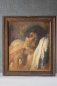 A framed pastel portrait of a young woman reclining in a chair. Indistinctly signed. H.58 W.50cm.