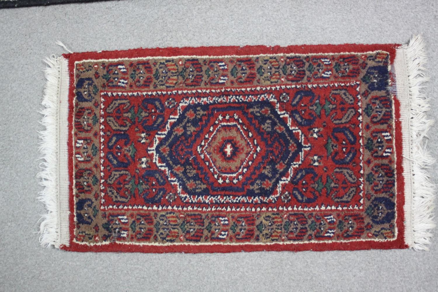 Two small Eastern rugs each on a red ground. L.110 W.60cm. (largest) - Image 3 of 8