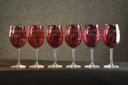 Six large hand etched Cranberry glass wine glasses, with a stylised foliate design. H.24 Dia.8cm.