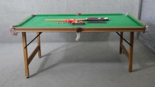 A Riley folding snooker table and accessories. H.83 W.190 D.87cm (Baize worn and legs in need of