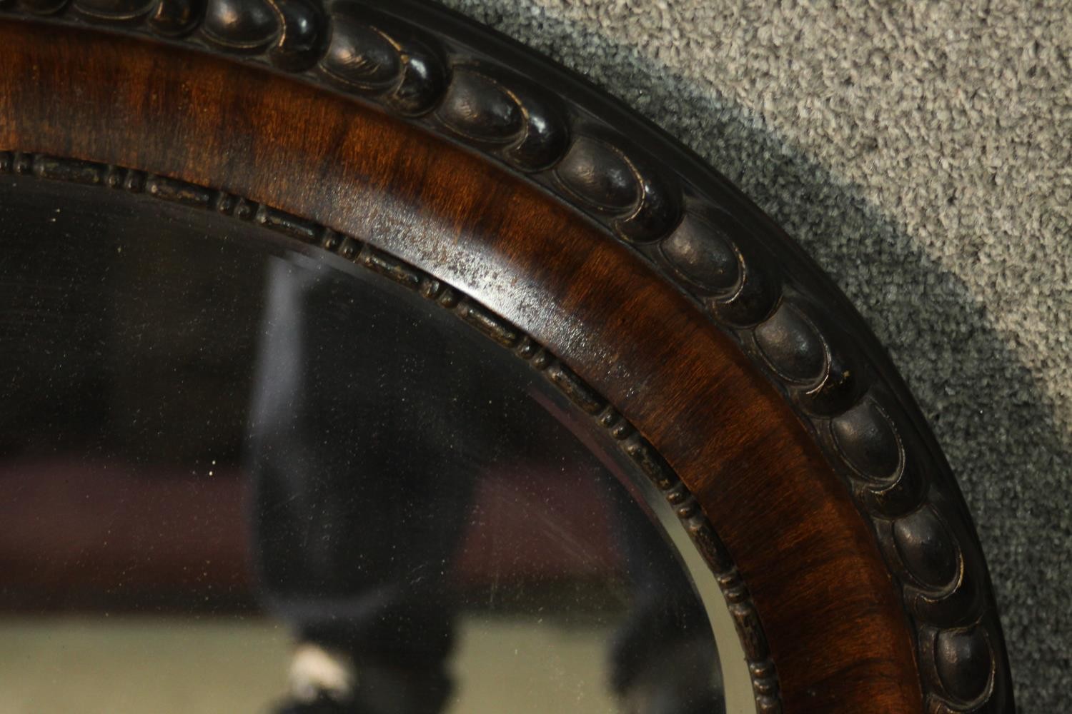 An early 20th century painted and lacquered framed oval wall mirror with bevelled plate. H.57 W. - Image 2 of 3