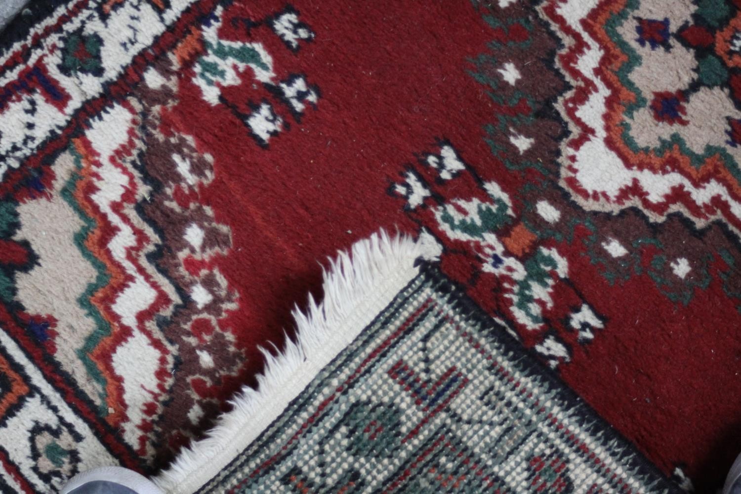 Two small Eastern rugs each on a red ground. L.110 W.60cm. (largest) - Image 7 of 8