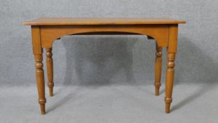 A 19th century pine console table with shaped frieze on turned tapering supports. H.73 W.117 D.53