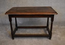 An antique oak hall or centre table on turned stretchered supports. H.76 x 112 x 63cm