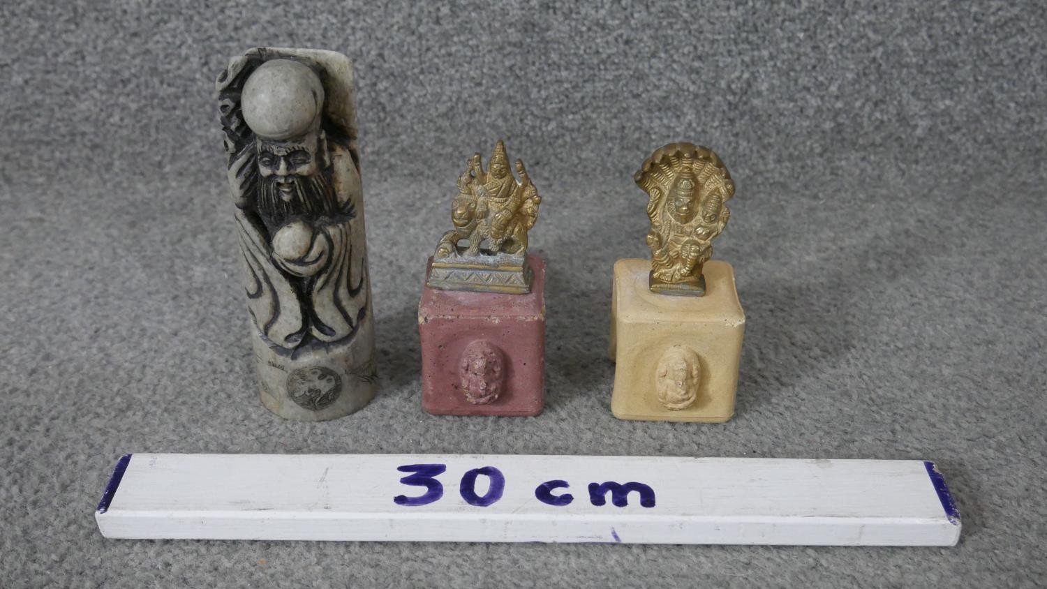 A carved Chinese soapstone chop in the form of an immortal along with two Indian brass deities on - Image 2 of 10